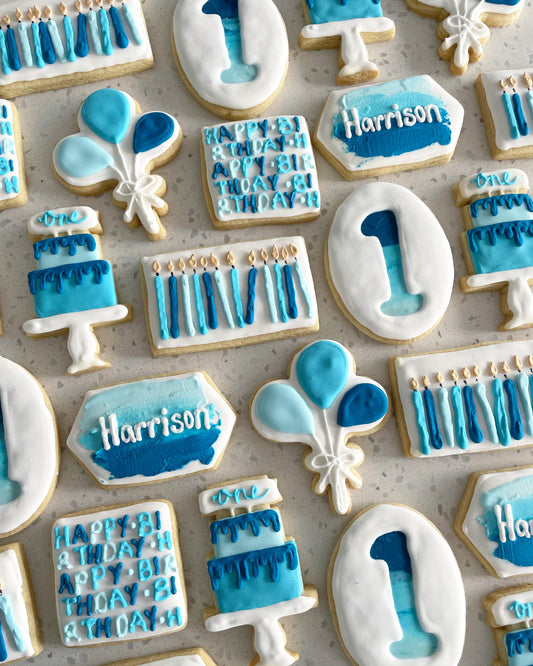 1st Birthday Cookies. Birthday cake, candle, balloon, name, number, and happy birthday designs. Blue and white cookies