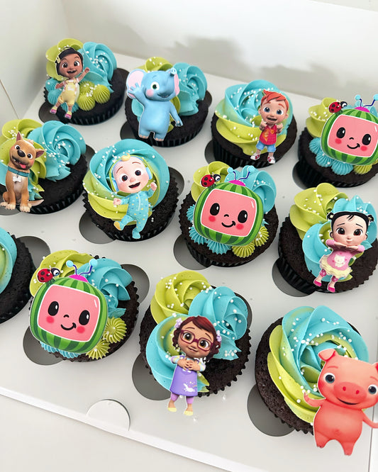 Cocomelon cupcakes with green and blue buttercream, sprinkles, and characters